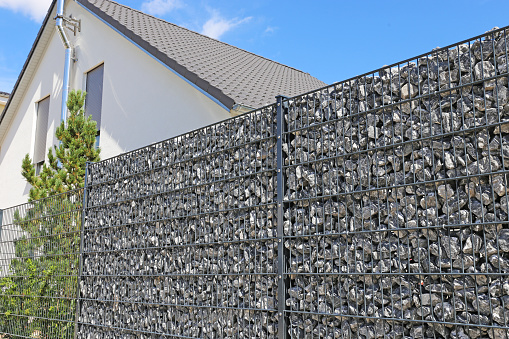 Close-up of a gabion as a modern and high-quality visual protection and property boundary on a residential house