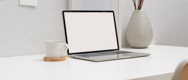 istock Minimal worktable with mock-up laptop, books, coffee cup and decorations 1255165919