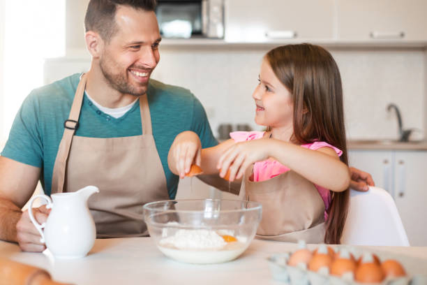 istock Cute Dad And Daughter Making Dough Baking Together At Home 1255165921