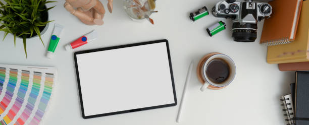 istock Designer worktable with mock-up tablet, stylus, camera, books and painting tools 1255166018