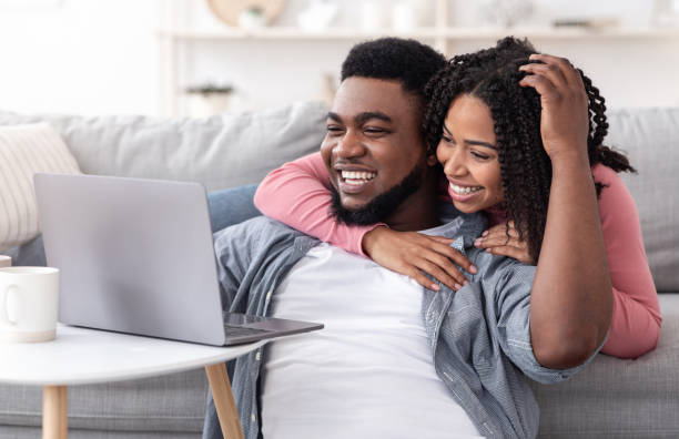 istock Caring Black Woman Supporting Boyfriend While He Working On Laptop At Home 1255166054