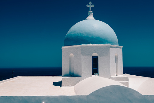 Beautiful White Church With Blue Dome And Sea Horizon In Santorini, Greece