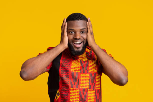 istock Super happy black guy touching his head, yellow background 1255167770