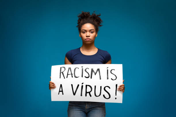 black girl holding banner for protest, racism is a virus - anti racism imagens e fotografias de stock