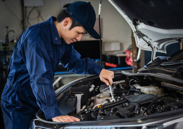 istock male mechanic using wrench to repair engine, car service 1255167937