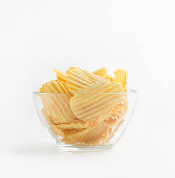 istock Ribbed chips in glass plate isolated on white background 1255169233