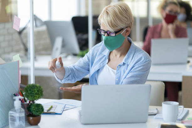 istock Disinfecting hands before starting to work after coronavirus pandemic 1255169361