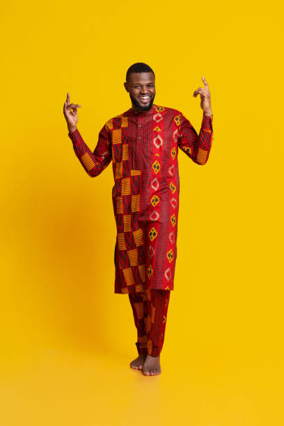 istock Cheerful black man gesturing over yellow background 1255169561