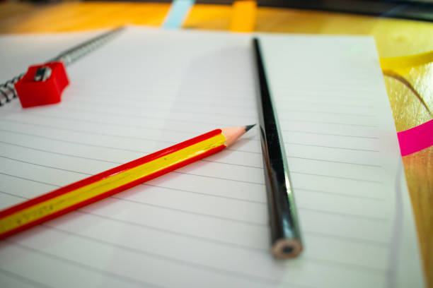istock notebook and pencil on the wooden table close up beautiful background 1255169805