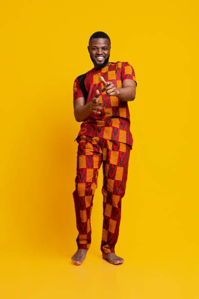istock Handsome black guy in authentic clothes flirting over yellow 1255170688