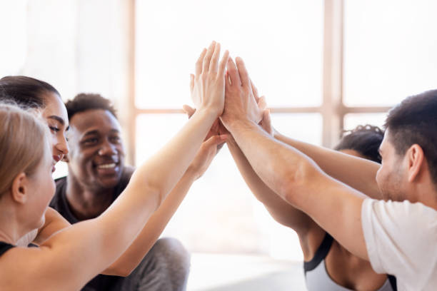 istock Teamwork And Unity. Young Multiethnic People Giving High Five To Each Other 1255171548