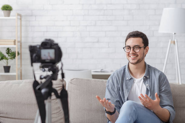 istock Modern online channel from home. Smiling man looking at camera 1255171780