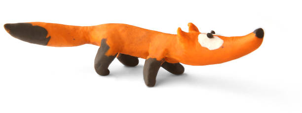 Cute fox made of plasticine isolated on white background.