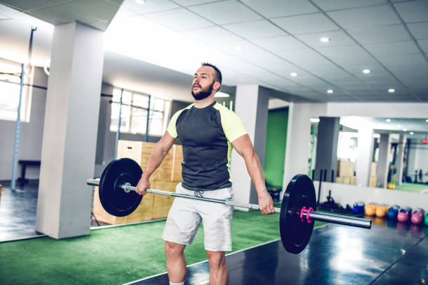 Strong Male Performing Deadlift Exercise In Gym