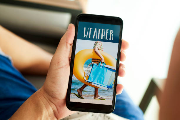 istock man and text weather in his smartphone 1255175559