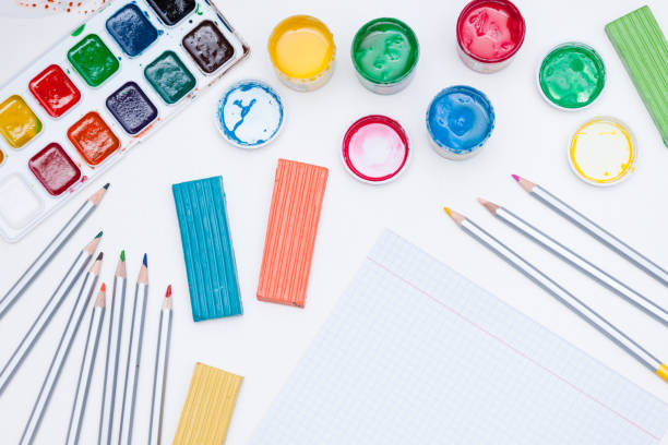 istock Notebook, paints, pencils on white background. Back to school. 1255175667