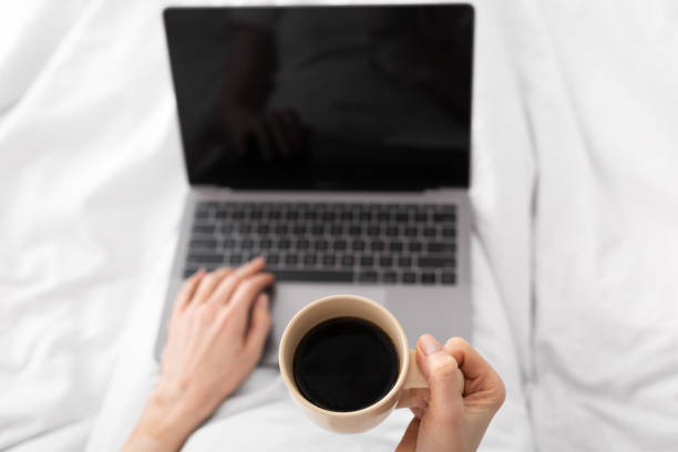 istock Woman drinking coffee and networking on laptop, pov 1255176787
