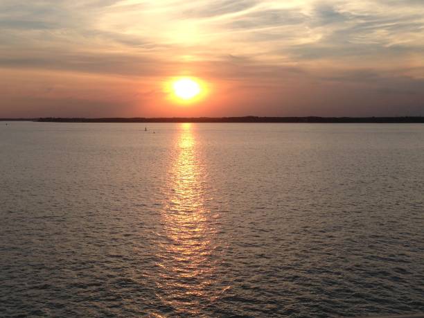 istock Sunset by the sea 1255177138
