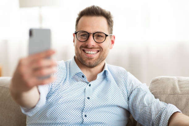 istock Happy man using smart phone for video call or selfie 1255178315