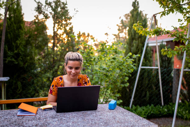istock Young woman works from home 1255178412