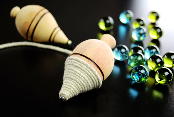 Wooden spinning top and marbles