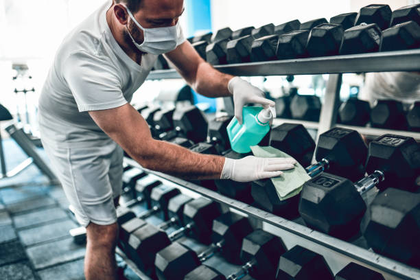 istock Gym Disinfection By Male With Face Mask 1255178634