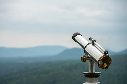 Telescope in front of big mountains