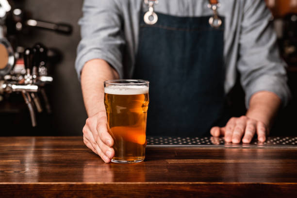 istock Favorite pub. Bartender gives beer on counter in pub interior 1255180459
