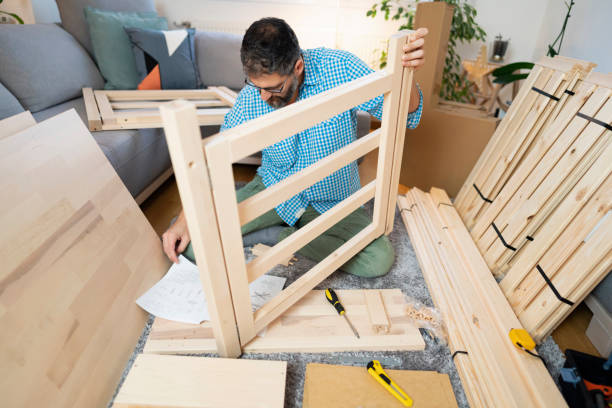 middle-aged handyman assembling furniture at home - instrument of measurement organization housing project housing development imagens e fotografias de stock