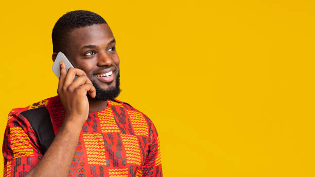 istock Interested african man talking on phone, looking at free space 1255181684