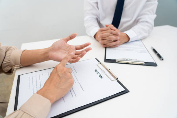 istock Interview the job and hiring, businessman candidate at job interview explaining about his profile to business manager in modern office space. Business consulting or employment concept 1255183020
