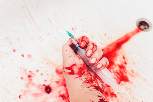 Bloody in sink with flowing red blood. Murder concept background syringe