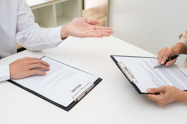 istock Interview the job and hiring, businessman candidate at job interview explaining about his profile to business manager in modern office space. Business consulting or employment concept 1255183124