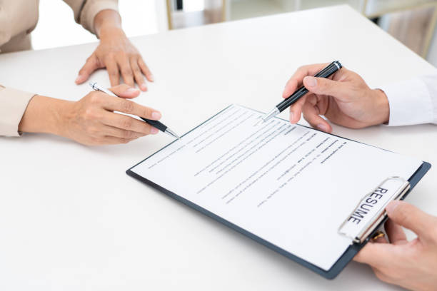 istock Interview the job and hiring, businessman candidate at job interview explaining about his profile to business manager in modern office space. Business consulting or employment concept 1255183233