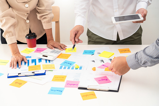 business people planning startup project placing sticky notes session to share idea on glass wall, Strategy Analysis Office Concept