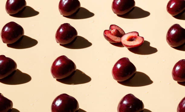 istock Sweet cherry on the yellow background pattern. Creative art food photo. 1255183264