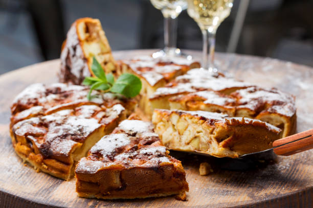 istock Authentic sponge cake with raisins, cinnamon and apples. Morning atmospheric lighting, fashionable trendy spot soft focus. Preparation for design creative menu. Culinary pastries. 1255183355