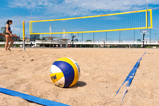 Beach, volleyball and sand with isolated ocean and sea with exercise, sport and fitness equipment. Summer, outdoor and training balls on the ground for health, games and workout activity in nature