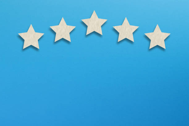 istock The best rating, five white star shape with copy space on blue background 1255186306