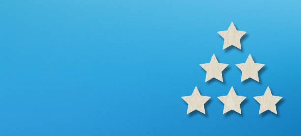 istock The best rating, five white star shape with copy space on blue background 1255186356