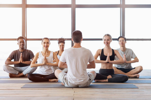 istock Multiethnic group of young people attending yoga class in modern studio 1255187061