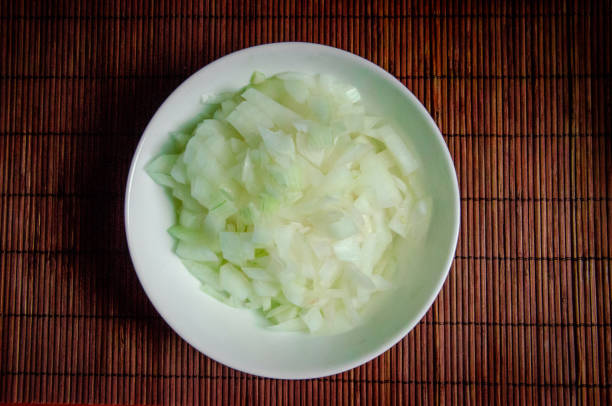 white fresh raw onion chopped finely in a white cup closeup top view white fresh raw onion chopped finely in a white cup closeup top view finely stock pictures, royalty-free photos & images
