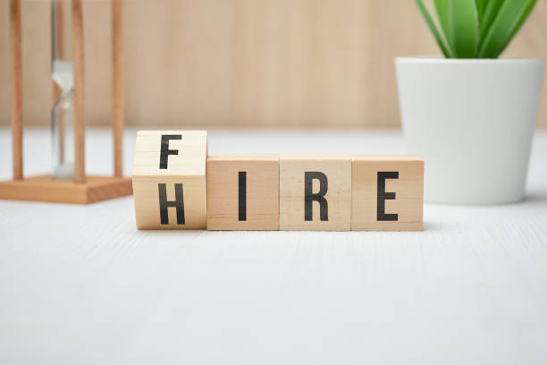 istock Abstract words fire and hire on wooden cubes. 1255189809
