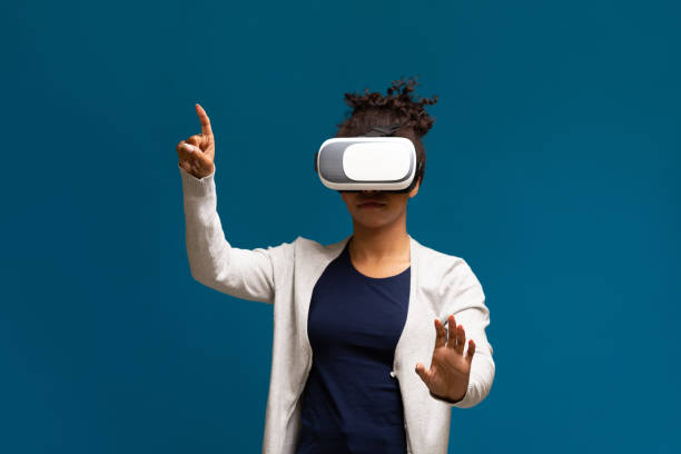 istock African american girl in VR headset and experiencing virtual reality 1255190064