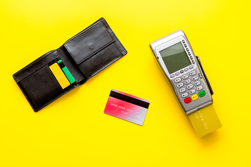 Payment by credit card. Terminal on background top-down.
