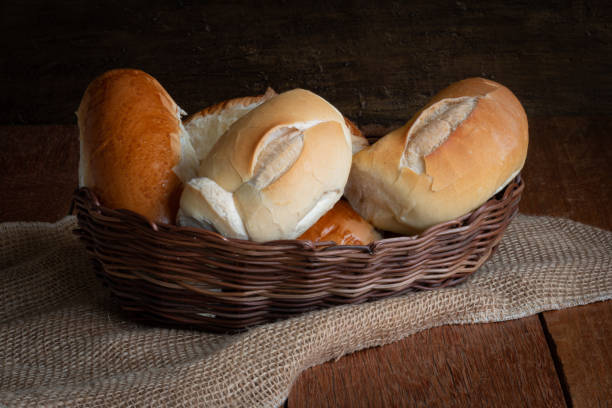 istock Basket with breads on rustic wooden background. 1255190397