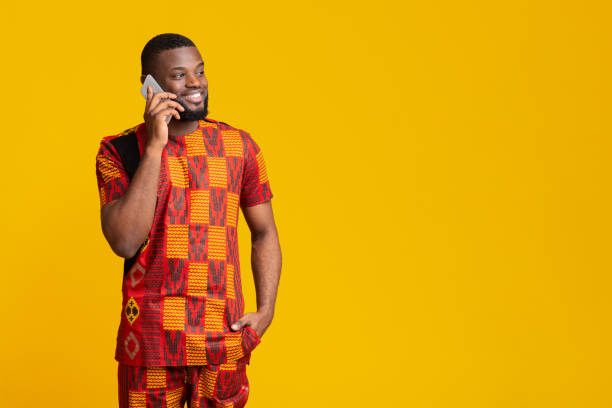 istock Positive african guy sharing good news, talking on phone 1255191109