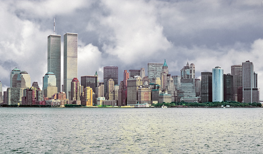 New York, NY, USA – October 28, 2018.  A black and white image of The Freedom Tower standing behind The Oculus on the site of the original World Trade Center buildings in NYC (New York City) in lower Manhattan in New York. A dramatic sky background highlights the image of this iconic structure.