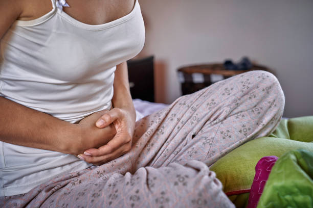 istock Hispanic young woman suffering PMS pain in bed 1255194626