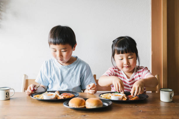 istock Siblings eating Takeaway meals at home 1255194651
